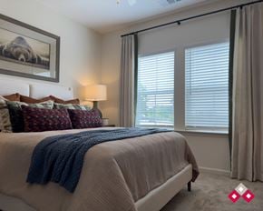 Flat Rock apartment for rent - A bedroom with a large bed and a window with blinds.