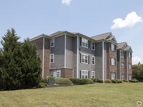 Columbia apartment for rent - a large apartment building with a grass yard in front