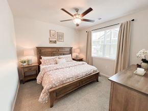 Boiling Springs apartment for rent - Pet-Friendly Luxury Apartments In Boiling Springs, SC - Grande At Geyser Falls - Carpeted Bedroom Featuring A Large Bed And A Ceiling Fan