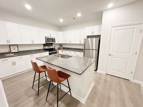 Boiling Springs apartment for rent - Pet-Friendly Luxury Apartments In Boiling Springs, SC - Grande At Geyser Falls - Kitchen with Island and Stainless Steel Appliances