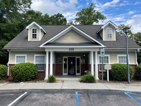 Summerville apartment for rent - the front of a building with a porch and a sign on the door