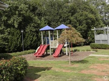 Anderson apartment for rent - A playground with a red slide and a blue canopy.