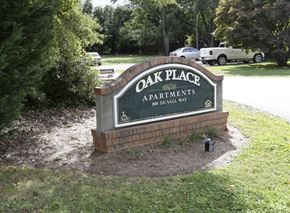 Anderson apartment for rent - a sign for oak place apartments on the side of a road