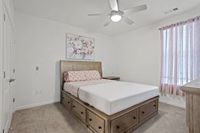 Charlotte townhouse for rent - Ovata at Reedy Creek bedroom with ceiling fan and carpet.