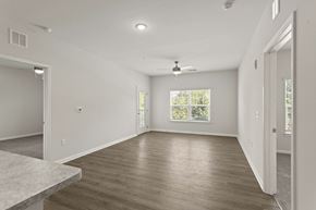 Greer apartment for rent - A spacious room with wooden flooring and a ceiling fan.