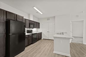 Greer apartment for rent - A kitchen with black appliances and wooden cabinets.