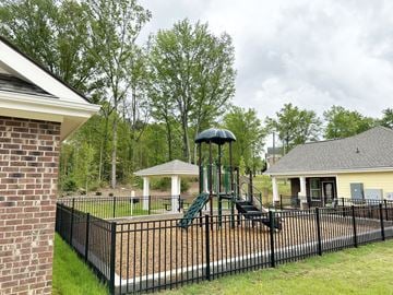 Easley apartment for rent - A playground with a green slide and a white gazebo.