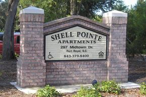 Beaufort apartment for rent - a sign for shell pointe apartments in front of a brick wall
