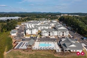 Flat Rock apartment for rent - an aerial view of a resort with buildings and a pool