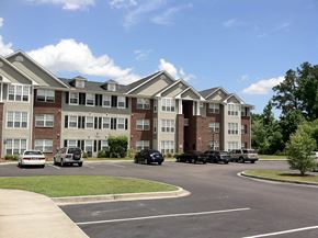 Summerville apartment for rent - an apartment building with cars parked in a parking lot