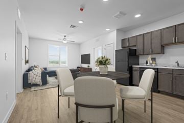 Tulsa townhouse for rent - A modern kitchen with a dining table and chairs.