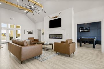 Pryor apartment for rent - A modern living room with a pool table and a fireplace.