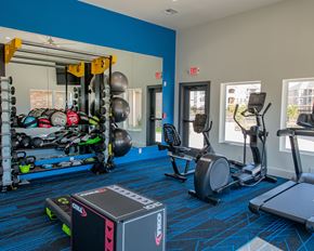 Oklahoma City townhouse for rent - A gym with a blue wall and a variety of exercise equipment.