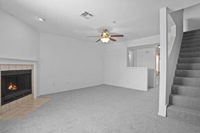 Oklahoma City apartment for rent - A living room with a fireplace and a staircase.