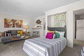 Oklahoma City apartment for rent - A bedroom with a large bed and a couch.