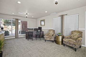 El Paso apartment for rent - A living room with grey carpet and a black chair.
