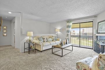 Wichita apartment for rent - A living room with a white couch and a coffee table.