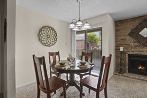 El Paso apartment for rent - A dining room with a table set for four and a fireplace.