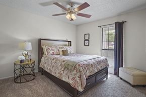 El Paso apartment for rent - A bedroom with a large bed and a ceiling fan.