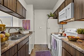 El Paso apartment for rent - A kitchen with a white refrigerator and a white stove.