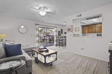 Oklahoma City apartment for rent - A living room with a grey couch and a coffee table.