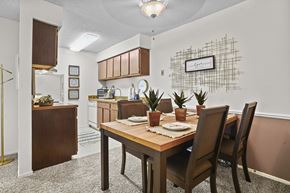 Wichita apartment for rent - A dining room with a table set for two and a plant on the table.