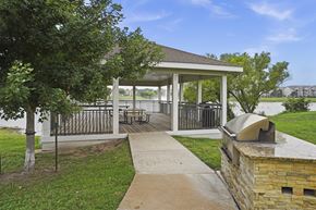 Wichita apartment for rent - A gazebo is surrounded by a fence and a brick wall.