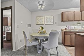 Wichita apartment for rent - A dining room with a table set for two.