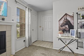 Wichita apartment for rent - A living room with a fireplace and a painting of a horse on the wall.
