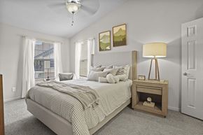 Edmond apartment for rent - A bedroom with a large bed and a ceiling fan.
