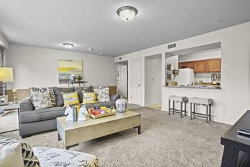 Wichita apartment for rent - A living room with a grey couch and a coffee table.