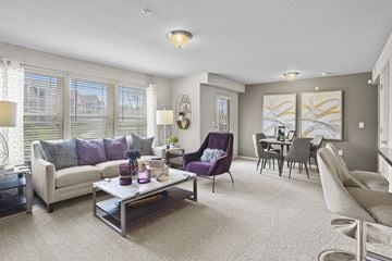 Wichita townhouse for rent - A living room with a purple chair and a grey couch.