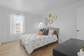 Stillwater apartment for rent - A bedroom with a bed, a chair, and a table.