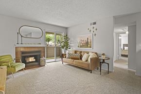 Amarillo apartment for rent - A living room with a fireplace, a couch, and a chair.