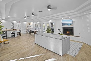 El Paso apartment for rent - A modern living room with a grey sofa and a fireplace.