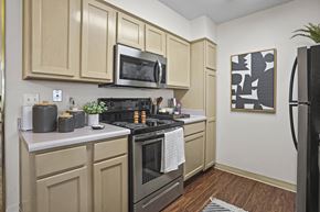 El Paso apartment for rent - A kitchen with a black stove top oven and a black refrigerator.