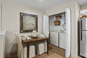 El Paso apartment for rent - A kitchen with a table set for two and a chocolate cabinet.
