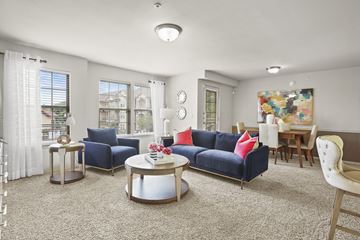 Lubbock apartment for rent - A living room with a blue couch and a coffee table.