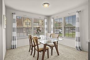 Lubbock apartment for rent - A dining room with a table and chairs.