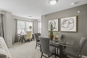 Lubbock apartment for rent - A dining room with a glass table and grey chairs.