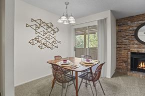 El Paso apartment for rent - A dining room with a brick fireplace and a table set for two.