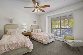El Paso apartment for rent - A bedroom with two beds and a ceiling fan.