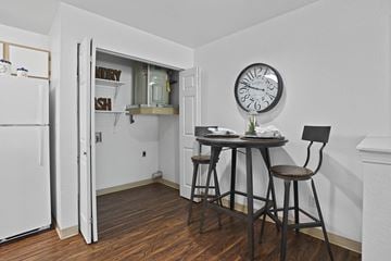 El Paso apartment for rent - A kitchen with a table and chairs and a clock on the wall.