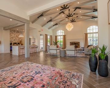 Little Rock apartment for rent - A large, open-concept living room with a patterned rug on the floor and a chandelier hanging from the ceiling.