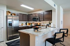 Belton apartment for rent - A kitchen with a marble countertop and a refrigerator.
