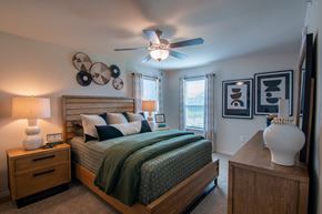 Belton apartment for rent - A bedroom with a bed, nightstand, and a ceiling fan.