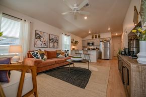 Oklahoma City triplex for rent - A living room with a couch, a coffee table, and a ceiling fan.