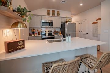 Oklahoma City triplex for rent - A kitchen with a white countertop and a clock on it.