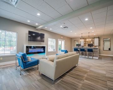 Oklahoma City apartment for rent - A living room with a blue chair and a white couch.