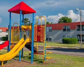 Oklahoma City apartment for rent - A playground with a red and yellow slide.